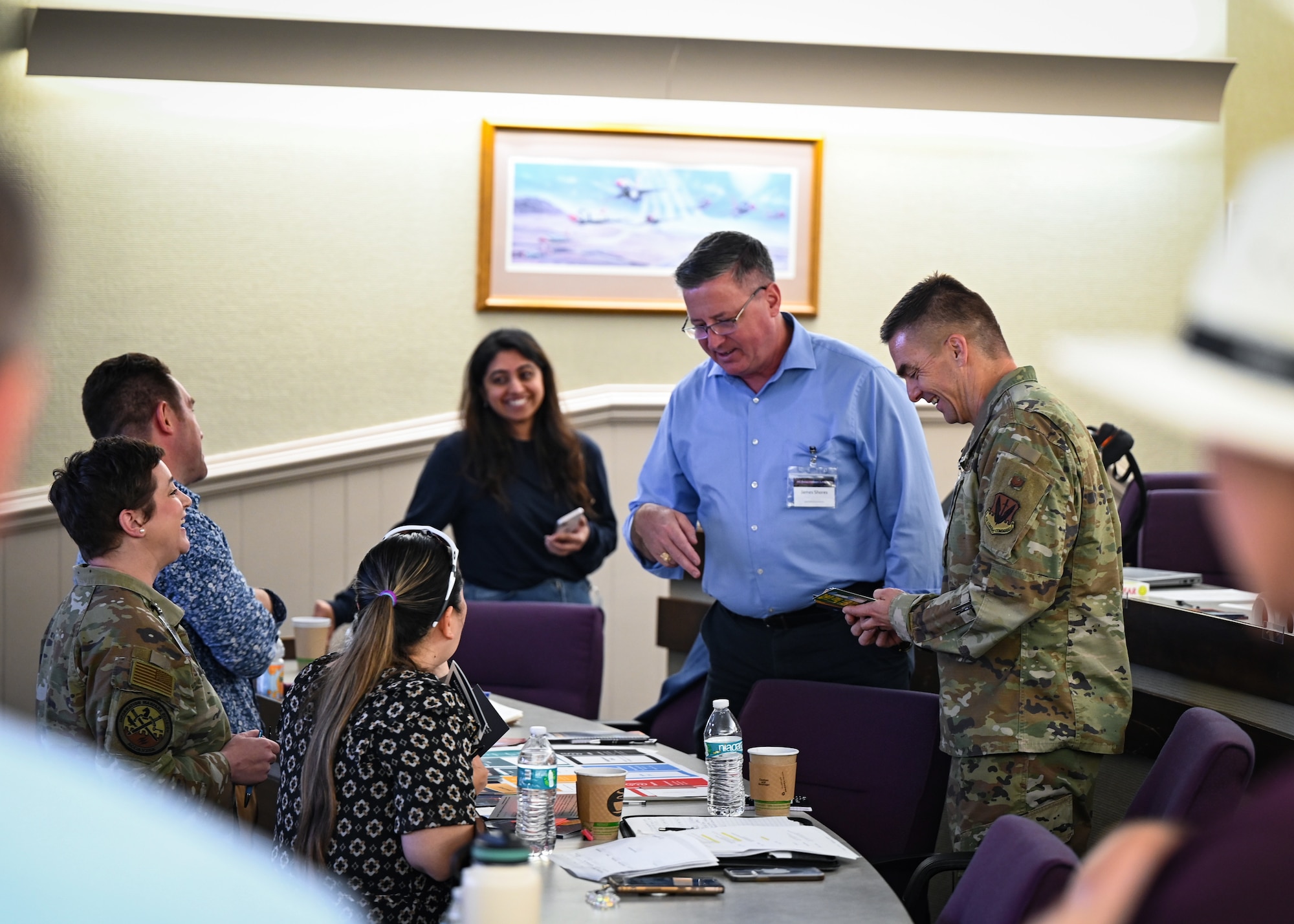 A group of participants laugh while playing a game during an Artificial Intelligence acquisition literacy course