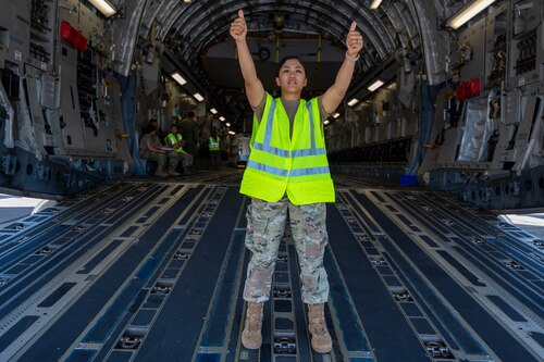 Master Sgt. Reiko Lovan, medical technician and flight chief for nursing services for the 624th Aeromedical Staging Squadron, facilitates safe patient movement while on a C-17 Globemaster III aircraft static display during exercise Rim of the Pacific 2024. Forty-one Citizen Airmen from the 624th ASTS participated in the 29th exercise of the biennial RIMPAC at Joint Base Pearl Harbor-Hickam, Hawaii, on July 17, 2024. During the training, the 624th ASTS members responded to a simulated mass casualty event. They treated and prepared patients in an En Route Patient Staging System for movement onto an AMBUS and C-17 aircraft. (U.S. Air Force Photo by James Bowman)
