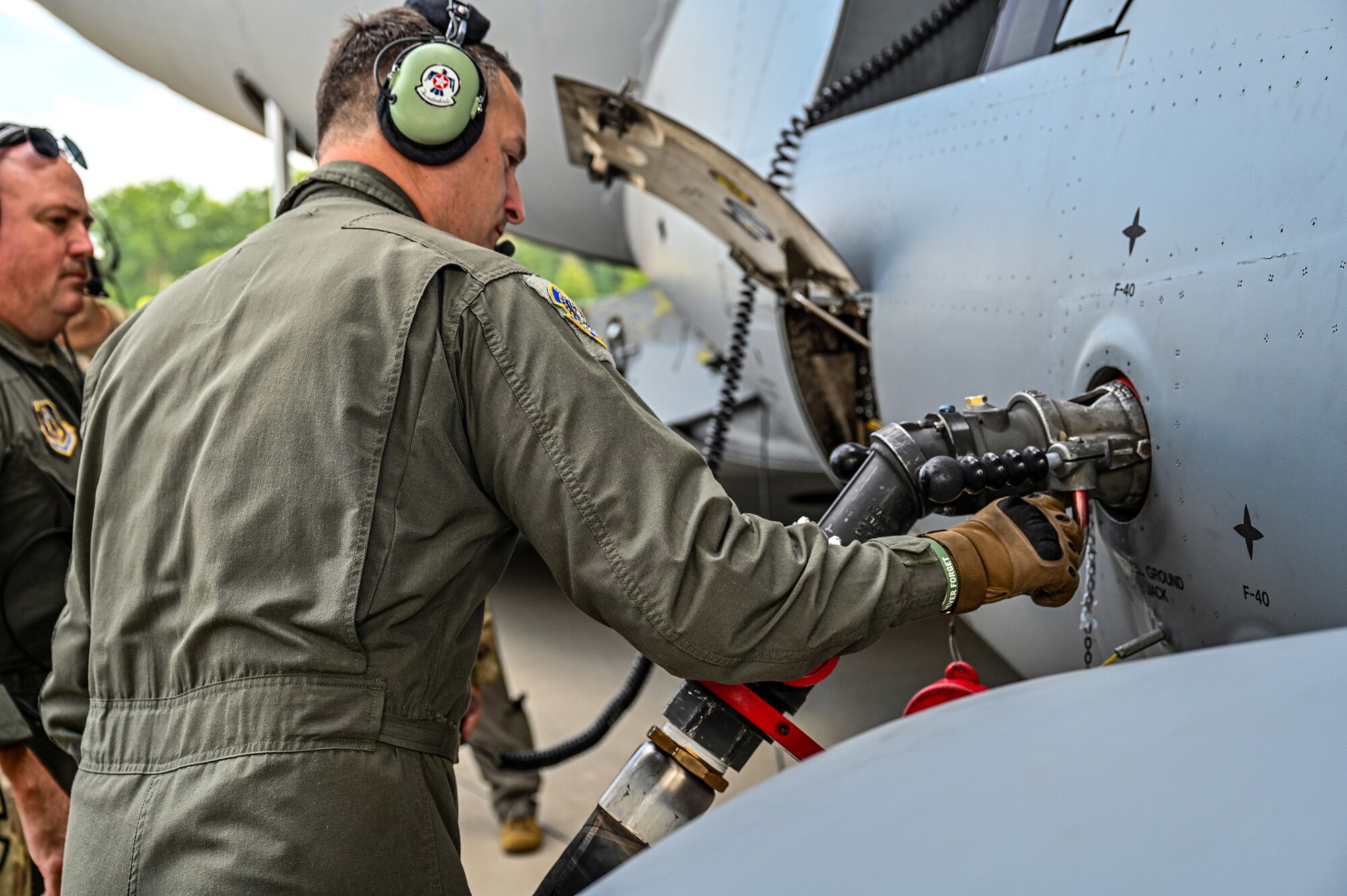 Tech. Sgt. Jay Benedict, 89th Airlift Squadron loadmaster, hooks up a fuel hose to a C-17 Globemaster III during specialized fueling operations at Wright-Patterson Air Force Base, Ohio, Aug. 3, 2024. SFO training includes hot refueling, wet-wing defueling, and bulk fuel delivery systems, all which Airmen are evaluated on utilizing proper checklists. (U.S. Air Force photo/Tech. Sgt. Joel McCullough)