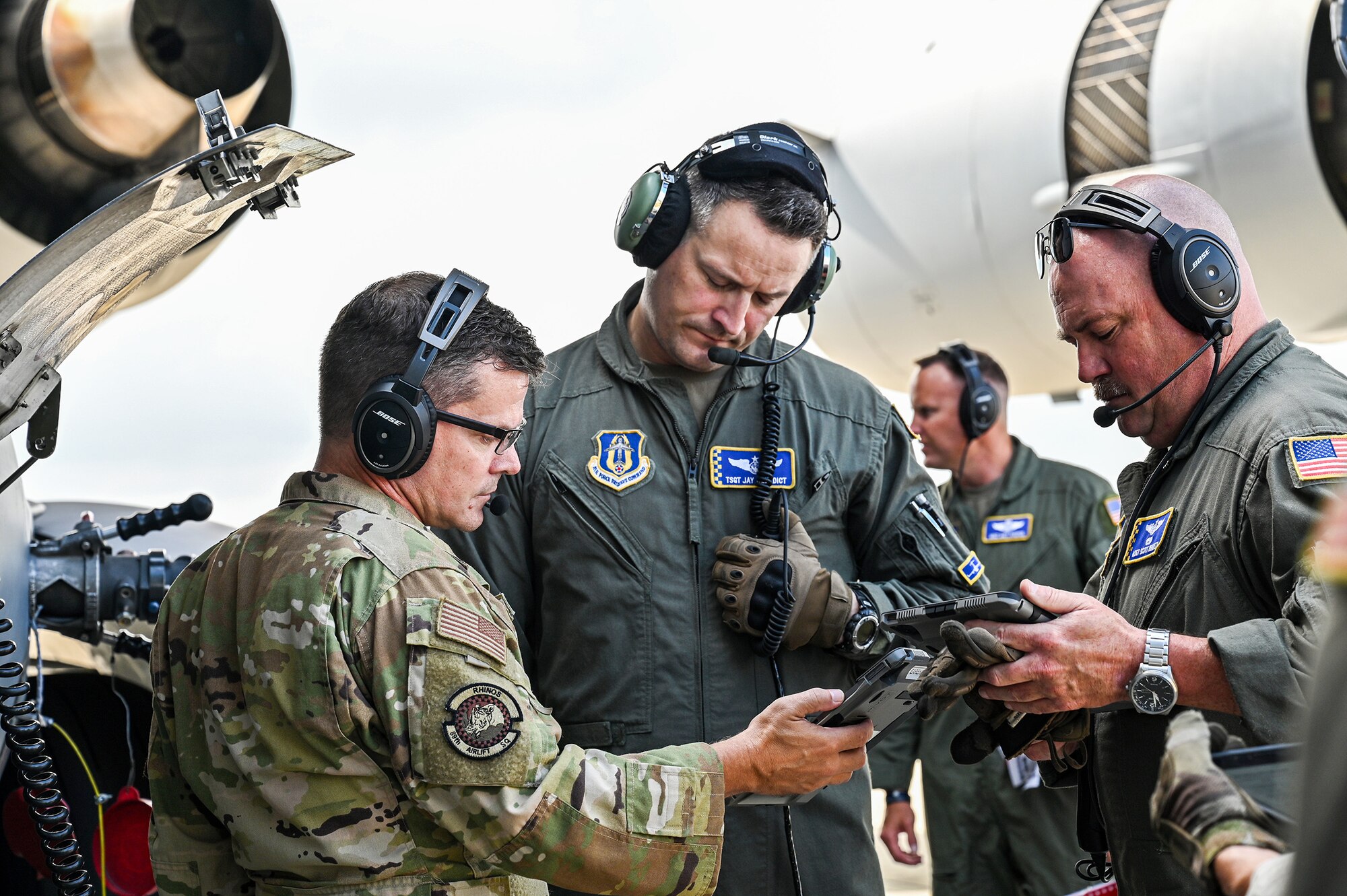 Tech. Sgt. Jay Benedict, 89th Airlift Squadron loadmaster, is trained and evaluated on connecting a fuel hose to a C-17 Globemaster III by Master Sgt. Kelly Earehart, 89th AS loadmaster, during wet-wing refueling at Wright-Patterson Air Force Base, Ohio, Aug. 3, 2024. Wet wing refueling was conducted as part of the unit’s specialized fueling operations, an annual requirement for aircrew. (U.S. Air Force photo/Tech. Sgt. Joel McCullough)