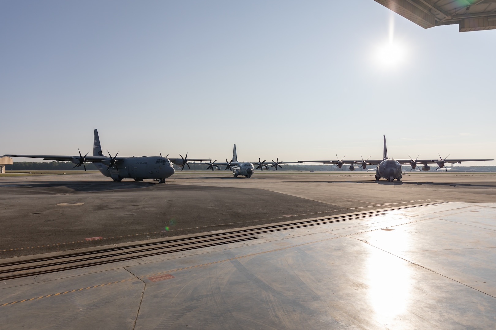 [From left to right] A C-130J Super Hercules, WC-130 Hercules, and AC-130J Ghostrider park on the runway Aug. 23, 2024 at Robins Air Force Base, Georgia. The three C-130 variants were staged to celebrate the aircraft's 70th anniversary since the first YC-130 flight on Aug. 23, 1954. (U.S. Air Force photo by Chris Bishop)