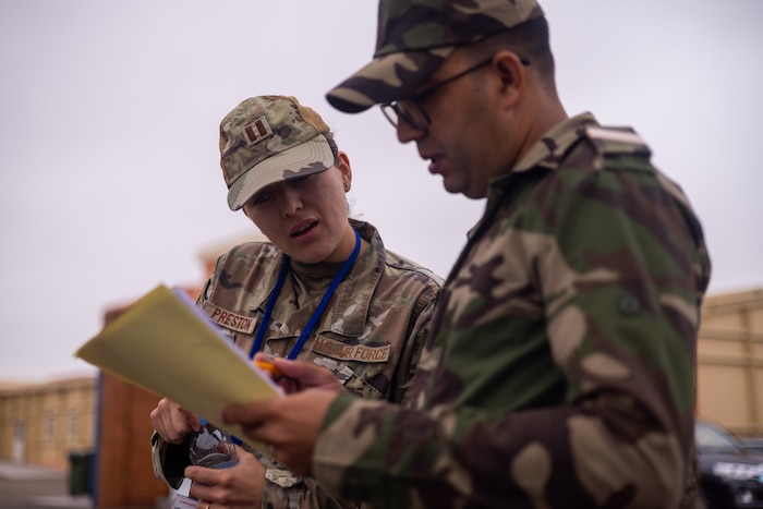 U.S. Air Force Capt. Cassaundra Preston, a U.S. Air Force Language-Enabled Airmen Program (LEAP) Scholar, interprets customs forms with a soldier from the Royal Moroccan Armed Forces on Aug. 15, 2024, at Agadir, Morocco.
