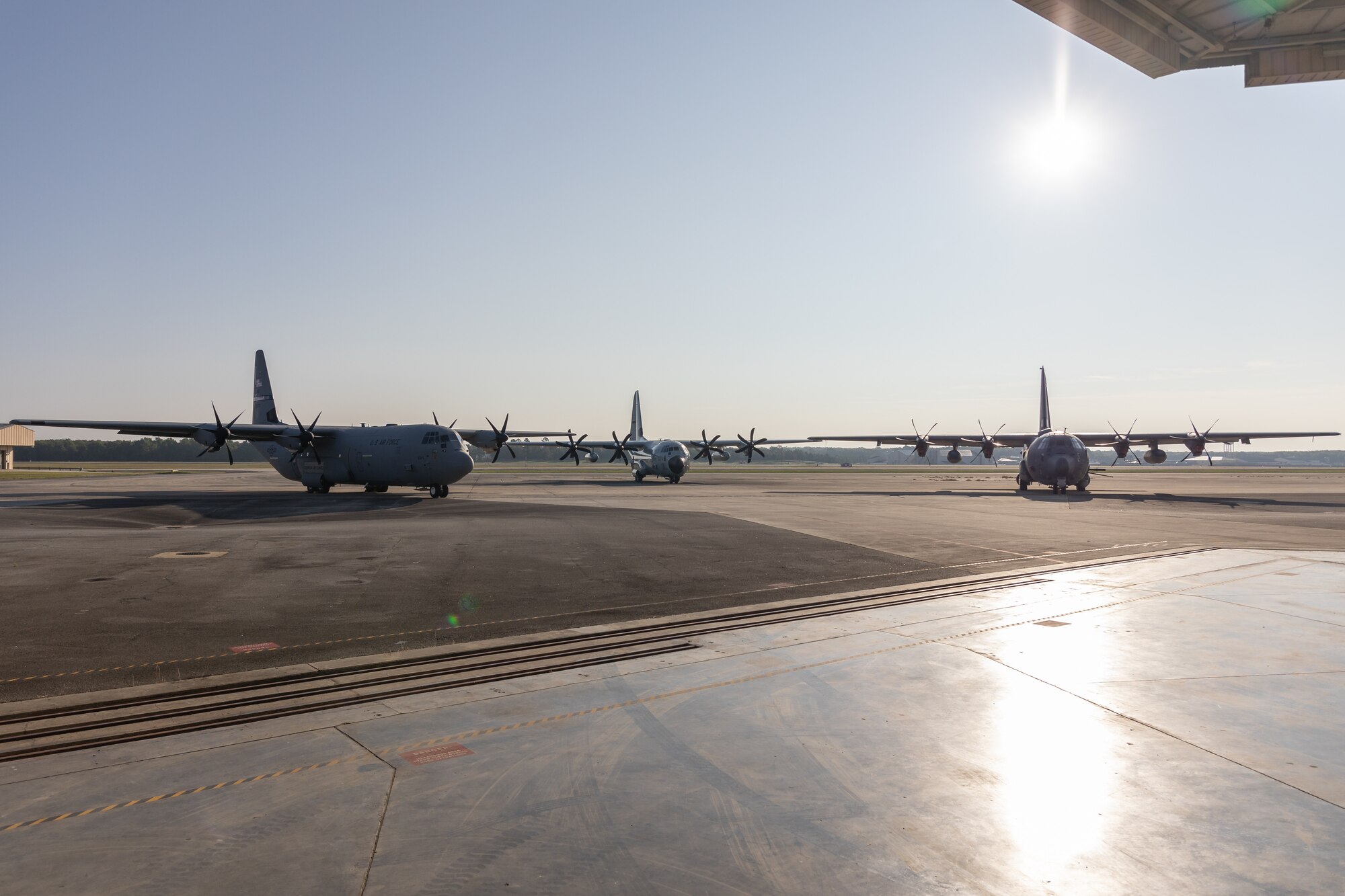 [From left to right] A C-130J Super Hercules, WC-130 Hercules, and AC-130J Ghostrider park on the runway Aug. 23, 2024 at Robins Air Force Base, Georgia. The three C-130 variants were staged to celebrate the aircraft's 70th anniversary since the first YC-130 flight on Aug. 23, 1954. (U.S. Air Force photo by Chris Bishop)