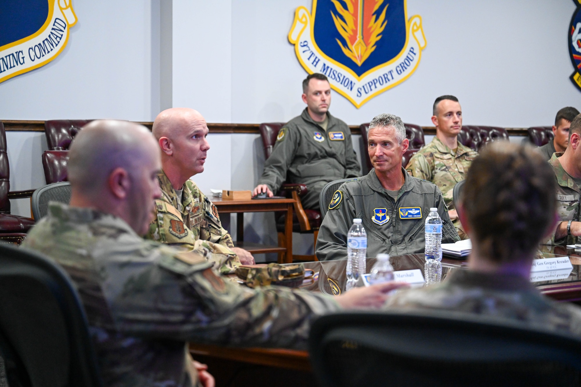 U.S. Air Force Maj. Gen. Gregory Kreuder, 19th Air Force commander, right, listens to a mission brief from Col. Jeff Marshall, 97th Air Mobility Wing (AMW) commander, at Altus Air Force Base, Oklahoma, Aug. 22, 2024. The wing mission brief introduced the mission of the 97th AMW and explained Marshall’s priorities of Airmen, mission and culture. (U.S. Air Force photo by Airman 1st Class Jonah Bliss)