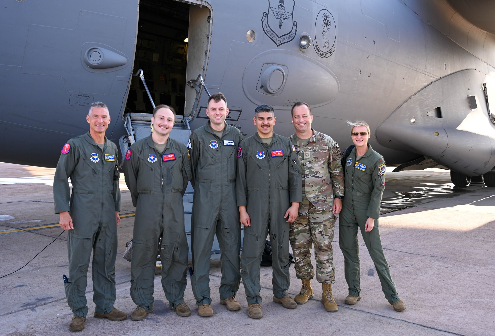 U.S. Air Force Maj. Gen. Gregory Kreuder, 19th Air Force (AF) commander, and Chief Master Sgt. Keith Scott, 19th AF command chief, pose for a photo with aircrew from the 58th Airlift Squadron, in front of a C-17 Globemaster III aircraft at Altus Air Force Base, Oklahoma, Aug. 23, 2024. The 19th AF command team experienced air refueling and airlift capabilities that highlight the core mission of the 97th Air Mobility Wing. (U.S. Air Force photo by Airman 1st Class Heidi Bucins)
