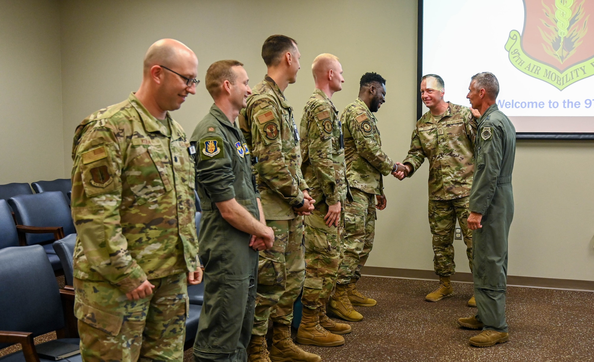 U.S. Air Force Maj. Gen. Gregory Kreuder, 19th Air Force (AF) commander, and Chief Master Sgt. Keith Scott, 19th AF command chief, shake hands with Airmen from the 97th Medical Group (MDG) during their visit to Altus Air Force Base, Oklahoma Aug. 23, 2024. During their visit, the 19th AF command team visited the 97th MDG to learn about current programs and areas needing further advocacy. (U.S. Air Force photo by Airman 1st Class Heidi Bucins)