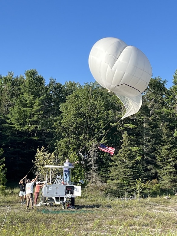 A tethered balloon with radio communications relay payload, launches.