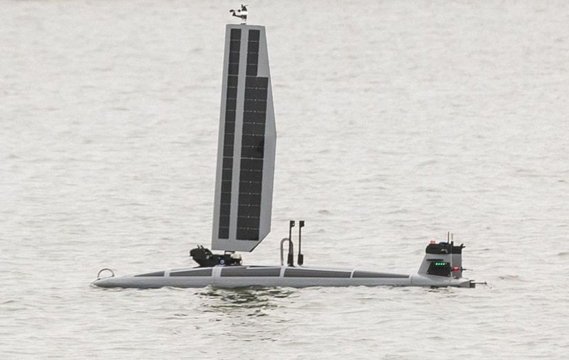 An Unmanned Surface/Undersea Vessel floats in a body of water.