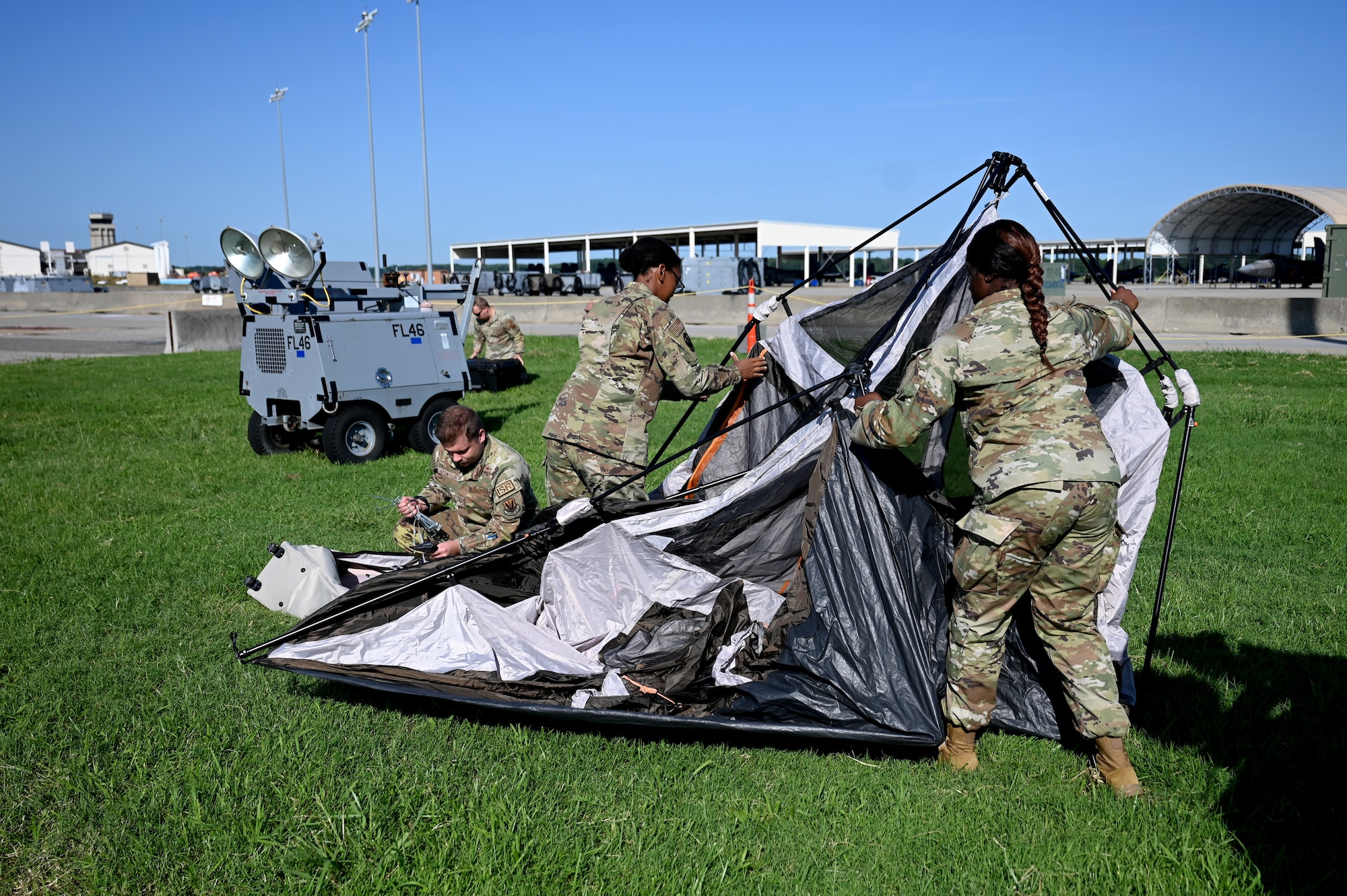 U.S. Airmen assigned to the 1st Operations Support Squadron from Joint Base Langley-Eustis, Virginia, and the 20th Operations Support Squadron from Shaw Air Force Base, S.C., assemble a tent during a demonstration of the fourth iteration Deployed Intelligence Combat Element kit at Joint Base Langley-Eustis, Virginia, Aug. 22, 2024. The DICE-4 kit allows intelligence analysts to establish a secure connection from anywhere in the world in just minutes. (U.S. Air Force photo by Staff Sgt. Kelsey Owen)