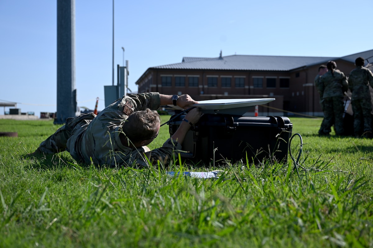 A U.S. Airman assigned to the 20th Operations Support Squadron assembles a satellite connection during a demonstration of the fourth iteration Deployed Intelligence Combat Element kit at Joint Base Langley-Eustis, Virginia, Aug. 22, 2024. The DICE-4 kit features a new satellite fixture, which is faster, more durable and more stable than its predecessor. (U.S. Air Force photo by Staff Sgt. Kelsey Owen)
