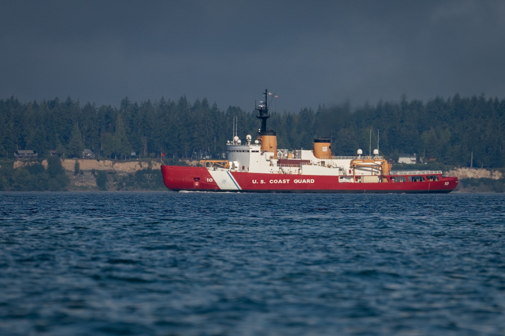 U.S. Coast Guard Cutter Polar Star (WAGB 10) transits Puget Sound near Bainbridge Island, Wash., as the cutter approaches its homeport of Coast Guard Base Seattle, Aug. 25, 2024. The crew returned to their homeport following a several-month dry-dock period in California. (U.S. Coast Guard photo by Petty Officer 2nd Class Steve Strohmaier)