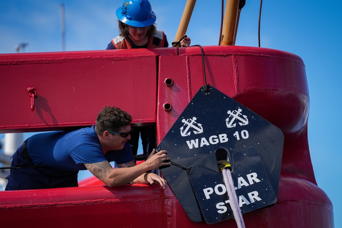 A crew member from U.S. Coast Guard Cutter Polar Star (WAGB 10) fastens a rat guard to a stern line after the cutter arrived to its homeport of Coast Guard Base Seattle, Aug. 25, 2024. The cutter is slated to remain in Seattle until beginning their Operation Deep Freeze deployment later in the year. (U.S. Coast Guard photo by Petty Officer 2nd Class Steve Strohmaier)