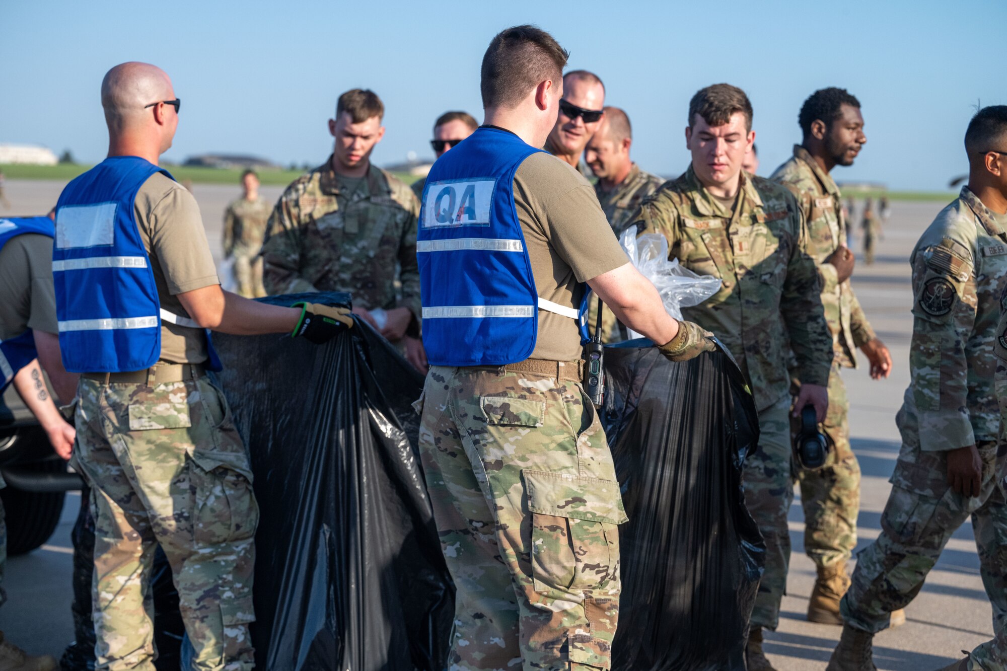 Team McConnell Airmen conduct a foreign object debris (FOD) walk following the Frontiers in Flight Air Show Aug. 26, 2024, at McConnell Air Force Base, Kansas. FOD included materials such as rocks, loose hardware, and litter from the air show. (U.S. Air Force photo by Airman 1st Class Paula Arce)