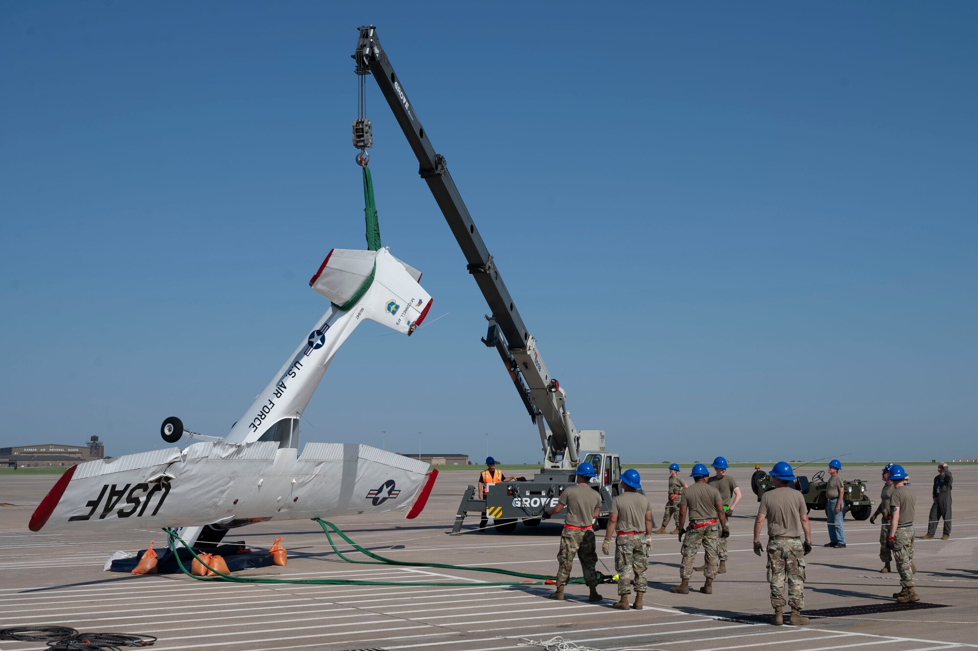 Airmen from the 22nd Aircraft Maintenance Squadron Crash Damage or Disabled Aircraft Recovery team used airbags, forklifts and cranes to raise, pull and stabilize a flipped aircraft Aug. 26, 2024, at McConnell Air Force Base, Kansas. The aircraft was flipped during a thunderstorm with wind gusts of up to 54 mph Aug. 25, 2024. The storm caused damage to several visiting aircraft and vendor stands leading to the cancelation of the second day of the Frontiers in Flight Airshow. (U.S. Air Force photo by Airman 1st Class Gavin Hameed)
