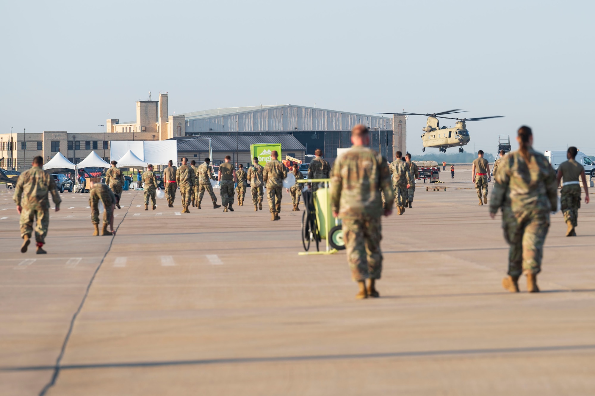 Airmen assigned to the 22nd Air Refueling Wing conduct a foreign object debris (FOD) walk following the Frontiers in Flight Air Show Aug. 26, 2024, at McConnell Air Force Base, Kansas. The FOD walk included Airmen from every group in the wing to clear the flightline of materials such as rocks, loose hardware and litter from the air show. (U.S. Air Force photo by Airman 1st Class Gavin Hameed)