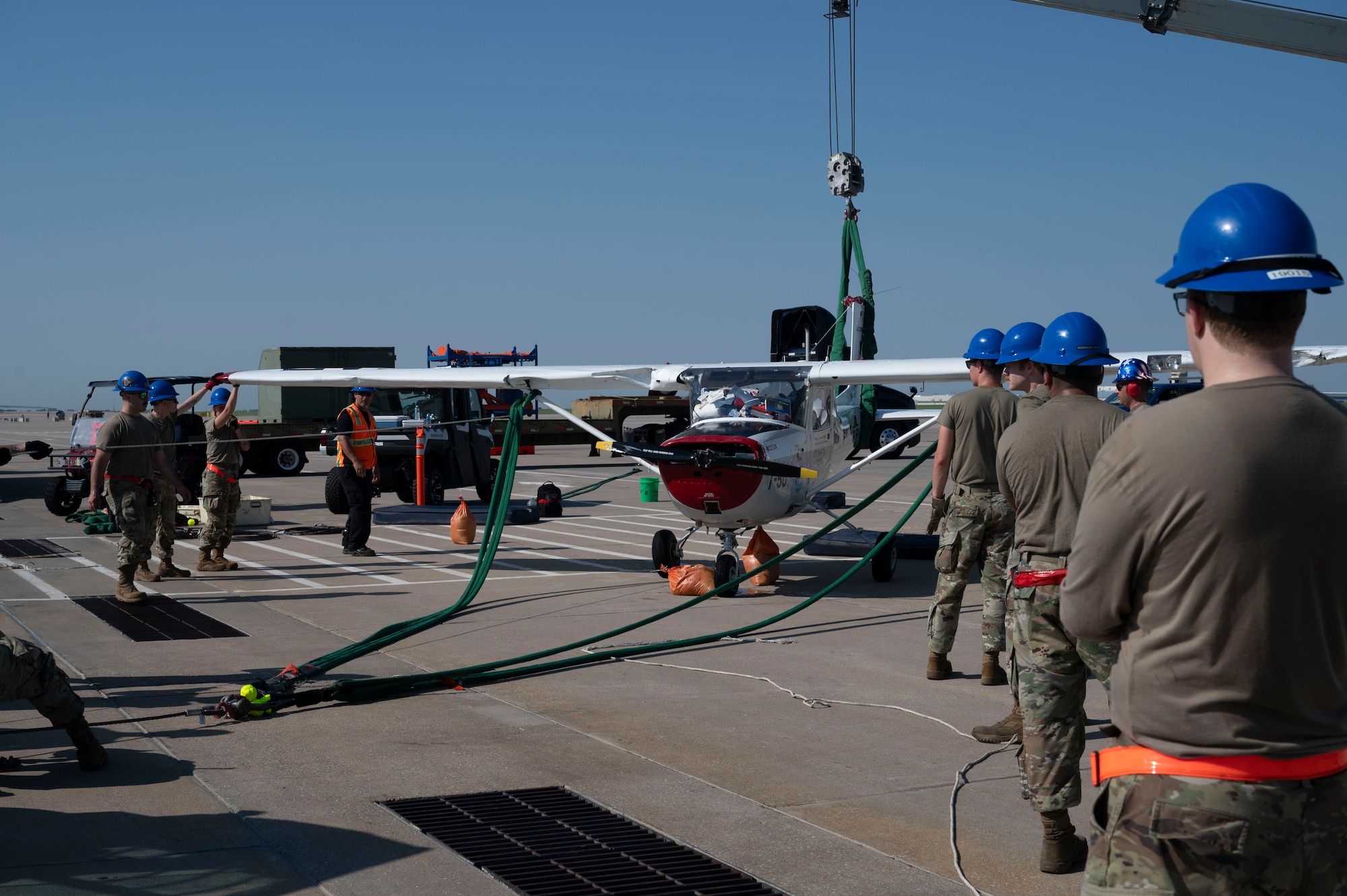 Airmen from the 22nd Aircraft Maintenance Squadron Crash Damage or Disabled Aircraft Recovery team successfully recover a flipped aircraft Aug. 26, 2024, at McConnell Air Force Base, Kansas. The CDDAR team used airbags, forklifts and cranes to raise, pull and flip the aircraft back on its wheels. (U.S. Air Force photo by Airman 1st Class Gavin Hameed)