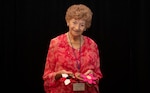 Patricia K. McMahan, a family member attending the DPAA’s Korean/Cold War Annual Government Briefings. displays her quilted flower coasters in Arlington, Va., Aug. 16, 2024. McMahan attends DPAA’s Korean/Cold War Annual Government Briefing throughout the U.S. to share her brother’s story and gives passes out the coasters to DPAA personnel and others in attendance. (U.S. Air Force photo by Senior Airman Kathy Duran)