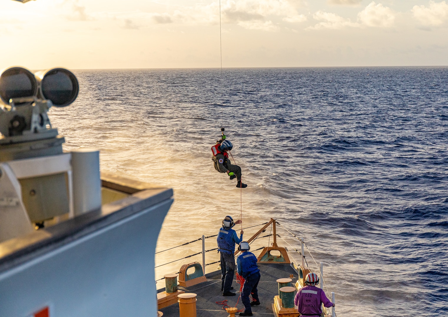 Coast Guard Cutter Campbell (WMEC 909) crew members conduct bow-hoisting operations with a Coast Guard Air Station Clearwater MH-65 Dolphin helicopter air crew, July 10, 2024, while underway in the Windward Passage. Coast Guard crew members are required to maintain readiness for emergency operations. (U.S. Coast Guard photo by Petty Officer 1st Class Eric Desirey)