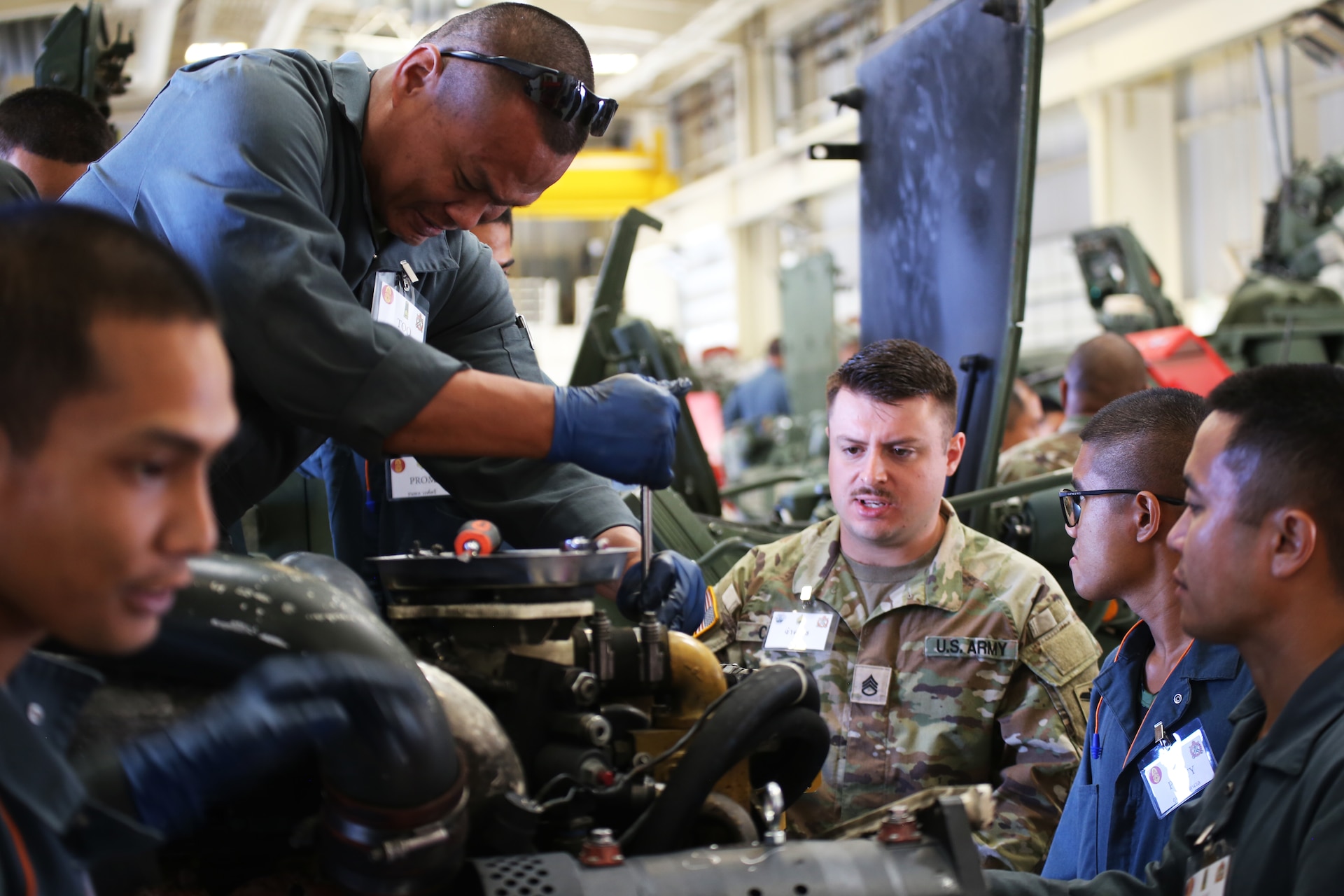 Staff Sgt. Jason Cruz, a technician at the Washington National Guard’s Maneuver Area Training Equipment Site, assists his Royal Thai Army counterpart during a Stryker maintenance subject matter expert exchange at the Washington National Guard’s Maneuver Area Training Equipment Site at the Yakima Training Center, August 21, 2024.