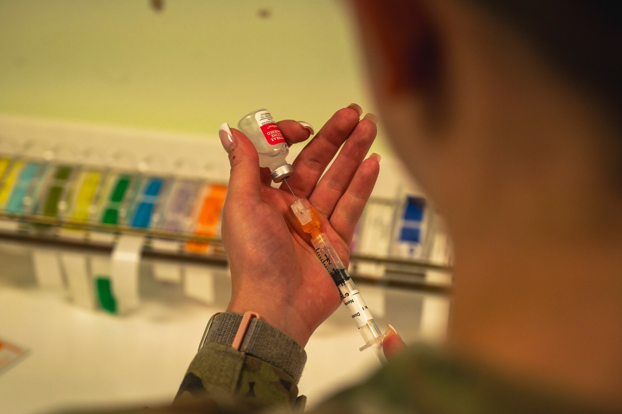 Senior Airman Emma Derosier, 8th Medical Group immunizations technician, prepares an anthrax shot