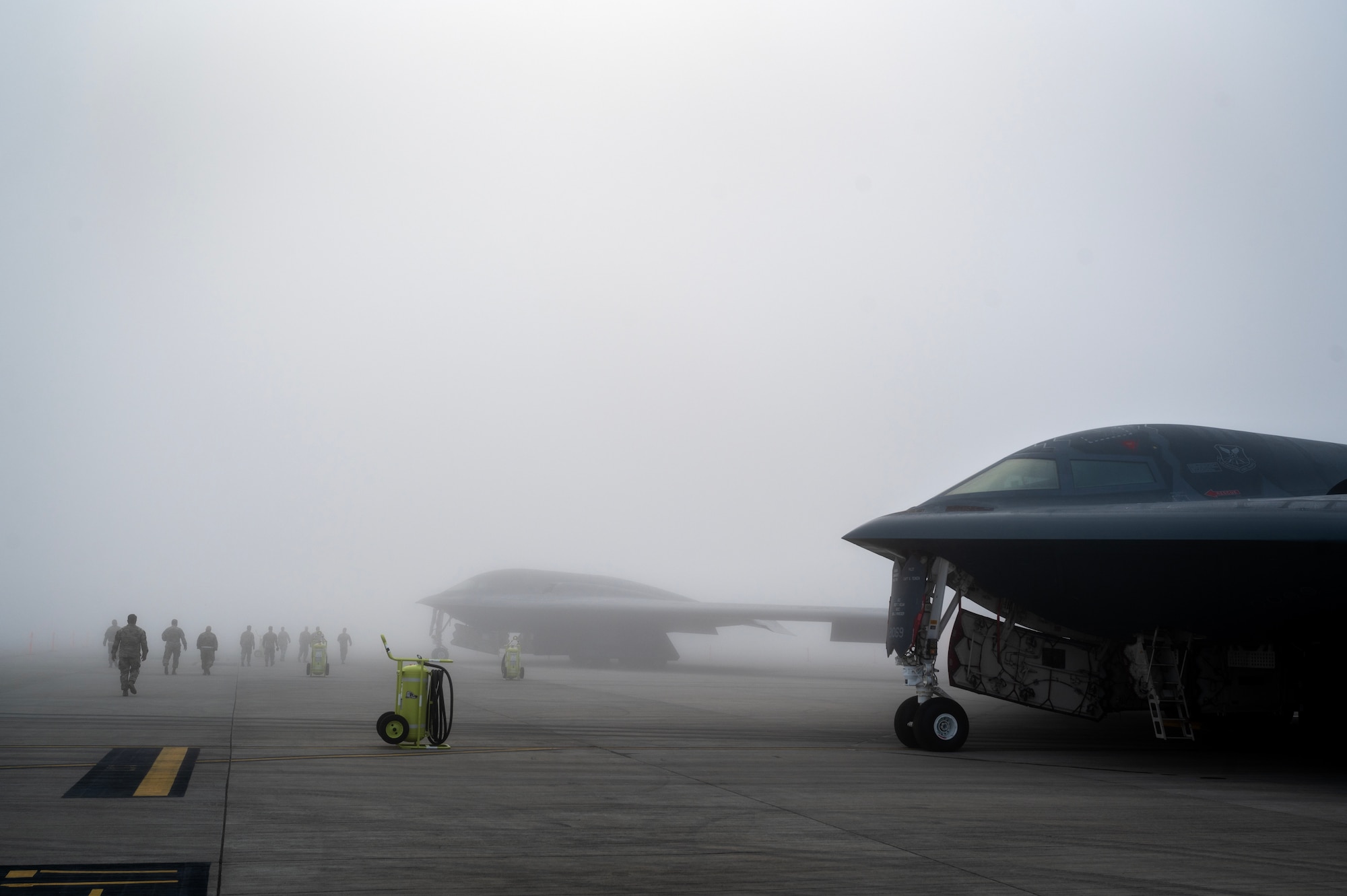 U.S. Air Force Airmen assigned to the 110th Expeditionary Bomb Squadron, walk on the flightline to conduct a reenlistment ceremony at Royal Australian Air Force Base Amberley, Australia, Aug. 23, 2024. Reenlisting in a foreign country is a special opportunity for service members tasked to deploy overseas. (U.S. Air Force photo by Master Sgt. Kenneth W. Norman)