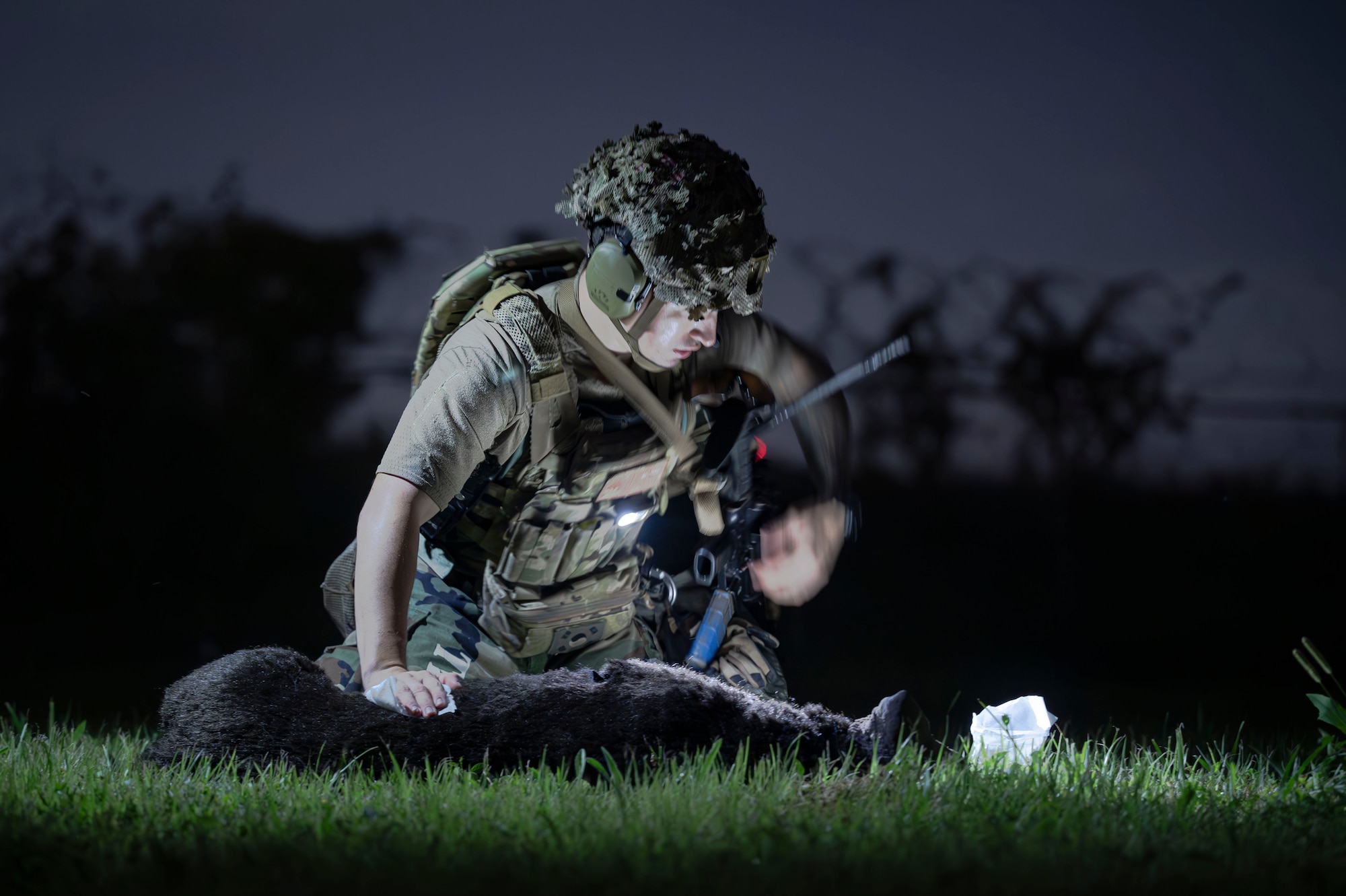A U.S. Air Force military working dog handler assigned to the 51st Security Forces Squadron practices first aid on an MWD mannequin during Ulchi Freedom Shield 24, at Osan Air Base, Republic of Korea, Aug. 22, 2024. Throughout the exercise, Airmen are evaluated on their warfighting capabilities, where they showcase their effectiveness and grit with combat readiness, defensive postures, and other Agile Combat Employment concepts. UFS 24 is an annual combined exercise conducted in support of the U.S.-ROK Mutual Defense Treaty that highlights the U.S. commitment to the alliance. (U.S. Air Force photo by Senior Airman Sabrina Fuller-Judd)