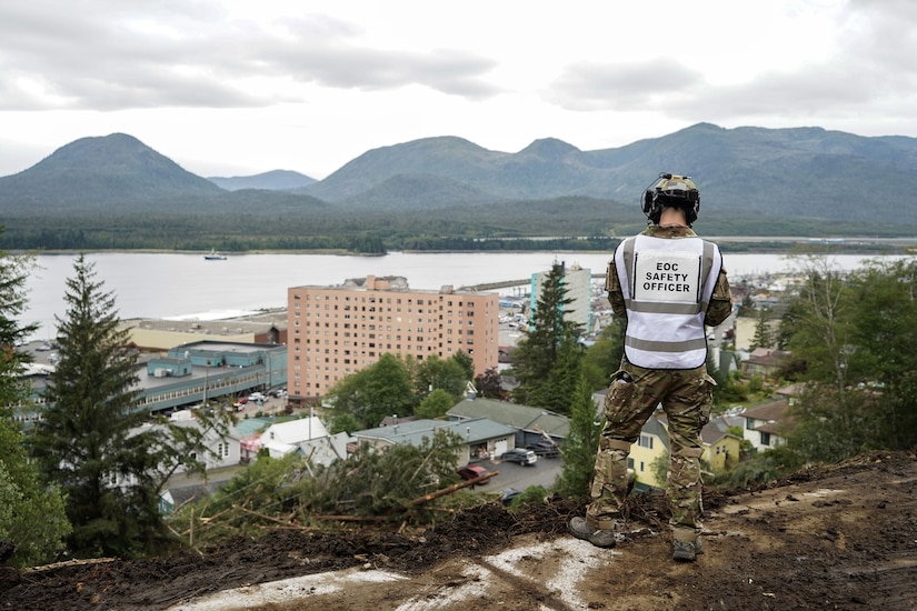 laska State Defense Force 2nd Lt. (AK) Matthew Nunnally, the acting Emergency Operations Center safety officer, surveys a debris field while responding to a major landslide in Ketchikan, Alaska, Aug. 27, 2024. Four Alaska Army National Guardsmen and two members of the Alaska State Defense Force mobilized on State Active Duty to assist with response and recovery efforts.