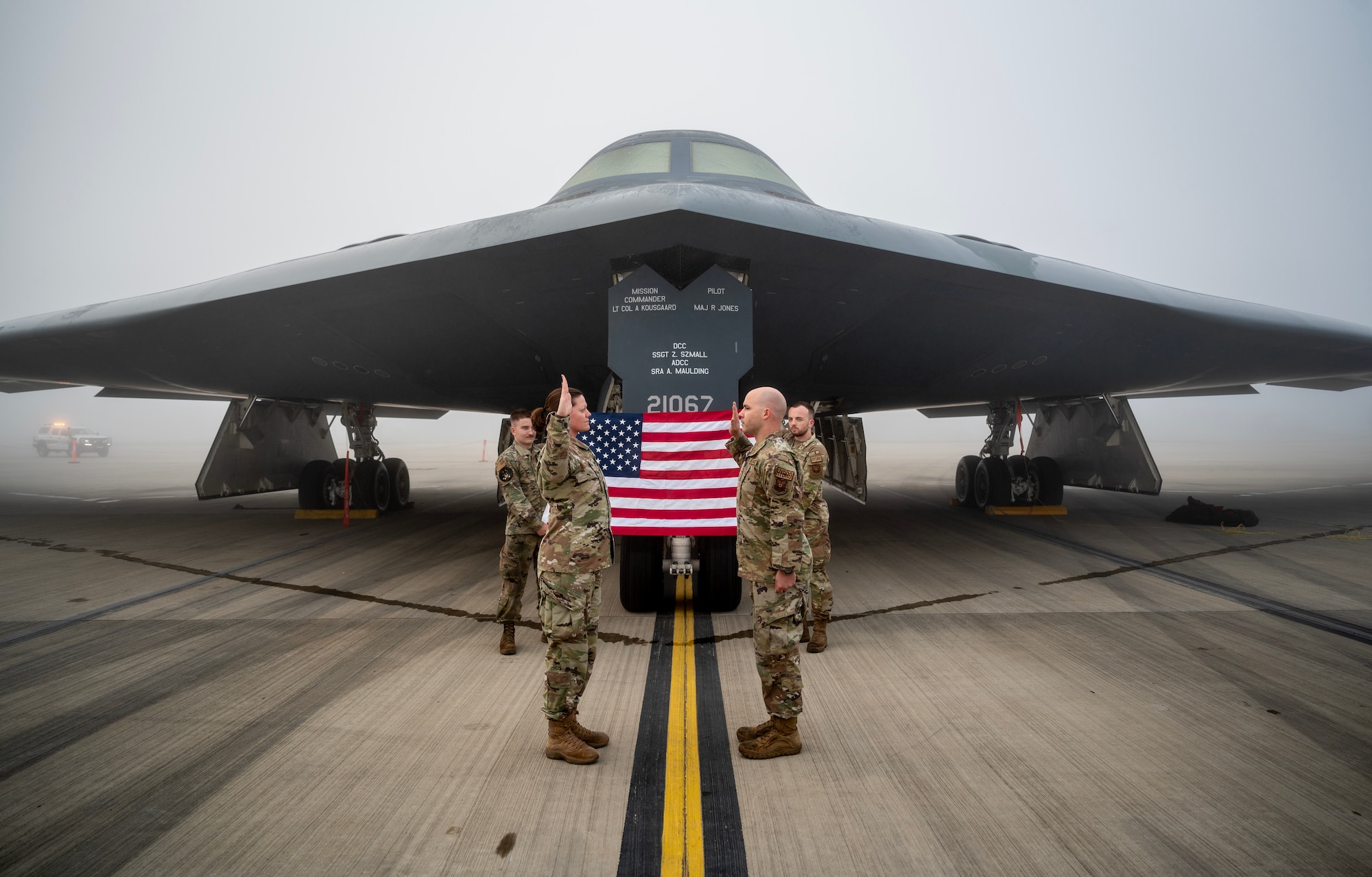 U.S. Air Force Tech. Sgt. Chase Frazee (right), 110th Expeditionary Bomb Squadron, noncommissioned officer in charge of the hydraulics section, is reenlisted into the USAF by Capt. Kaylynn Harms (left), 110th EBS, sortie generation flight commander at Royal Australian Air Force Base Amberley, Australia, Aug. 23, 2024. Frazee entered the U.S. Air Force on June 27, 2010 and intends to serve for at least 20 years. (U.S. Air Force photo by Master Sgt. Kenneth W. Norman)