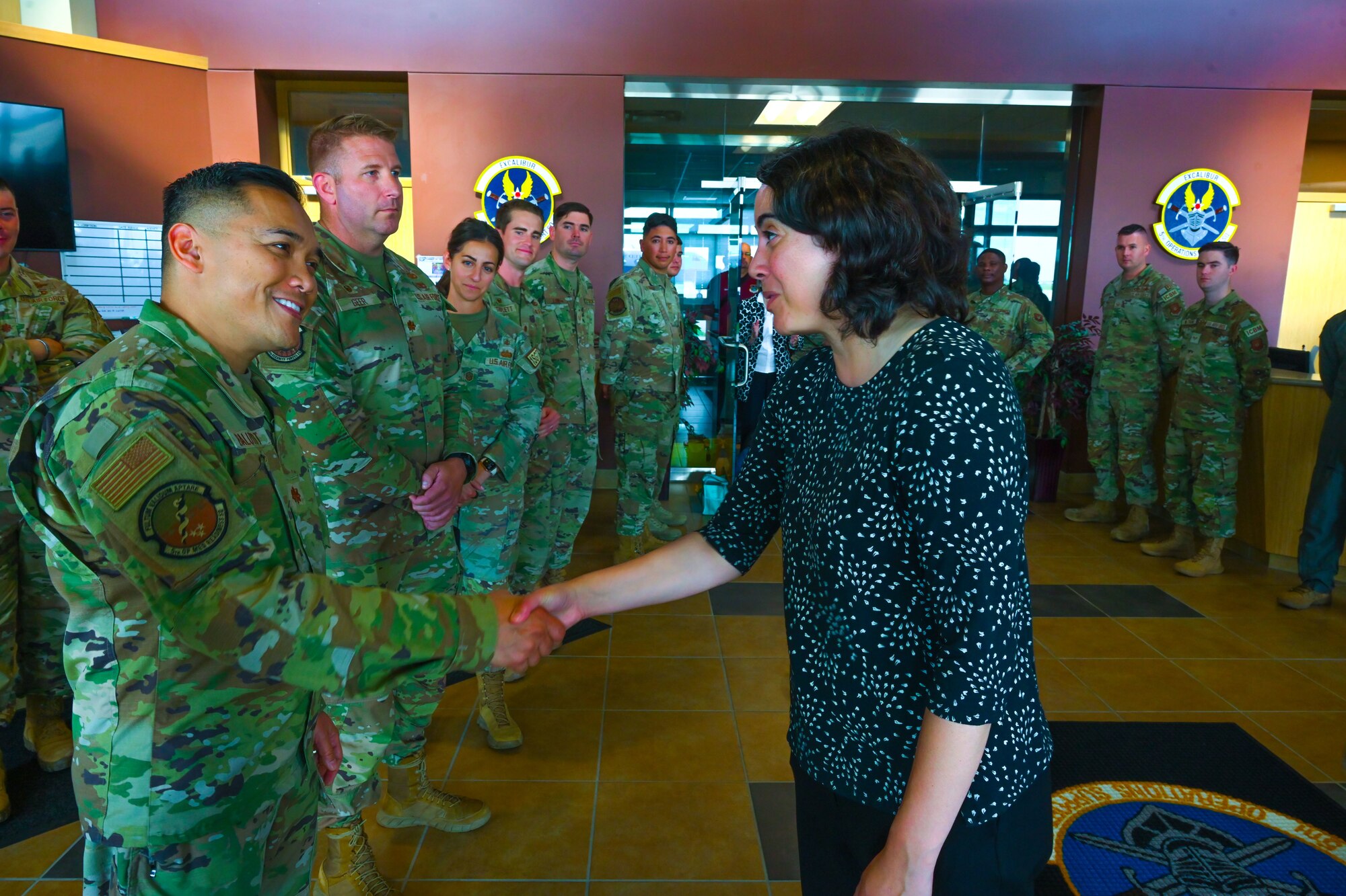 Under Secretary of the Air Force Melissa Dalton coins U.S. Air Force Maj. Rondre Baluyot, 5th Medical Group comprehensive dentist, during a visit to Minot Air Force Base, North Dakota, Aug. 27, 2024. While the focus of Dalton’s visit was nuclear modernization, she took the opportunity to recognize outstanding performers.