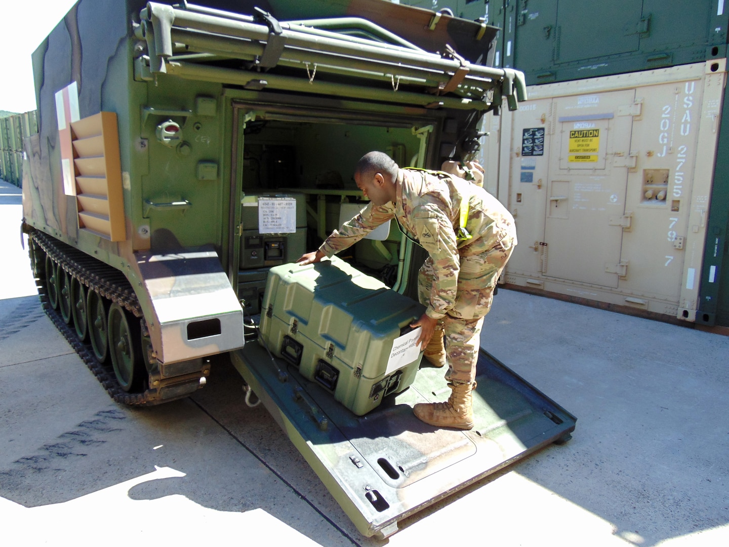 A medic with the 4th Battalion, 70th Armor Regiment, 1st Brigade Combat Team, 1st Armored Division, out of Fort Bliss, Texas, loads a medical set case onto an armored personnel carrier at the Army Prepositioned Stocks site in Korea, known as APS-4K, during Operation Pacific Fortitude.