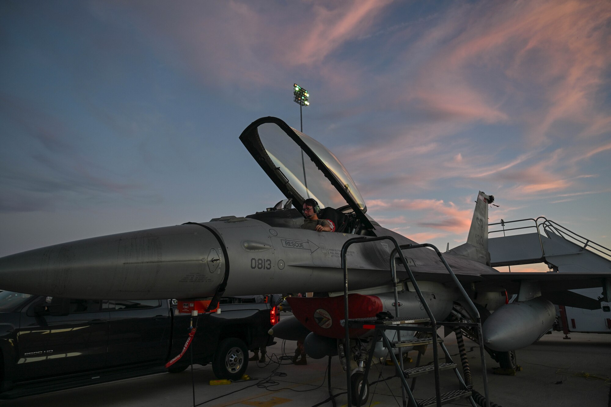 An Airman assigned to the 480th Fighter Generation Squadron, Spangdahlem Air Force Base, Germany, sits in the cockpit of a U.S. Air Force F-16 Fighting Falcon while members of the 87th Electronic Warfare Squadron, Eglin Air Force Base, Florida, assess the defensive system readiness during Bamboo Eagle 24-3 at Southern California Logistics Airport, Victorville, California, Aug. 5, 2024. Approximately 3,000 U.S. service members from across four military branches are expected to fly, maintain and support more than 150 aircraft from 24 units in more than 10 locations during Bamboo Eagle. (U.S. Air Force photo by Senior Airman Anna Smith)
