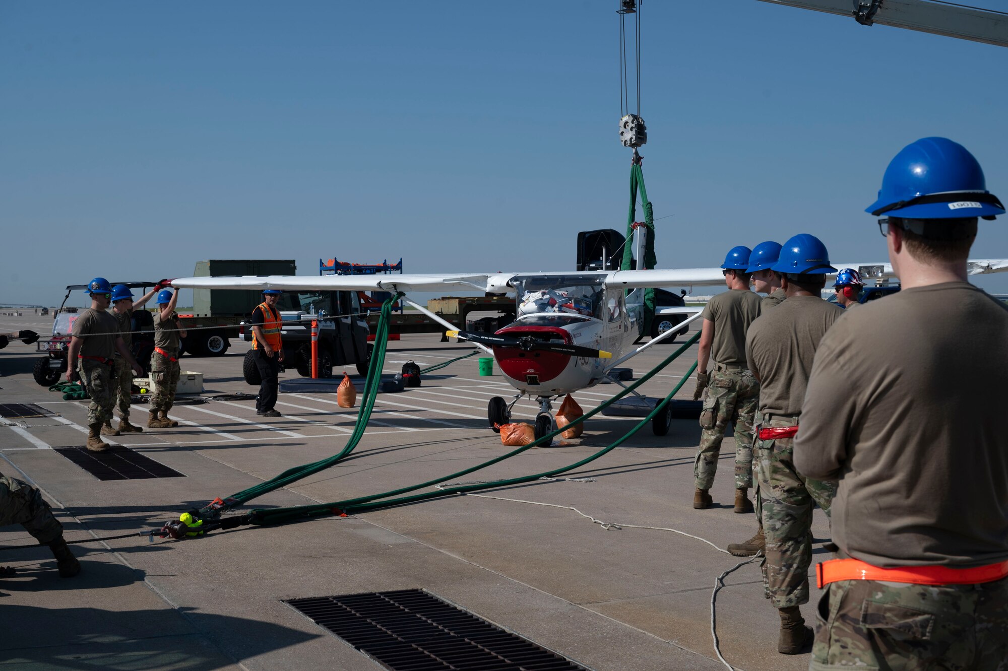 Airmen from the 22nd Aircraft Maintenance Squadron Crash Damage or Disabled Aircraft Recovery team successfully recover a flipped aircraft Aug. 26, 2024, at McConnell Air Force Base, Kansas. The CDDAR team used airbags, forklifts and cranes to raise, pull and flip the aircraft back on its wheels. (U.S. Air Force photo by Airman 1st Class Gavin Hameed)