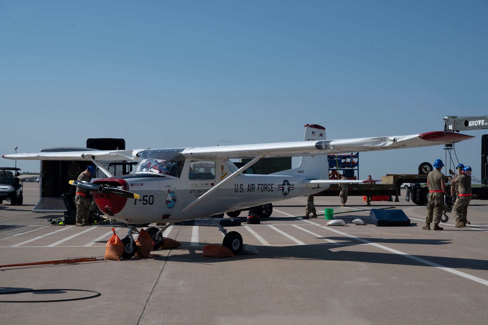 A Cessna 150 is righted by the 22nd Aircraft Maintenance Squadron Crash Damage or Disabled Aircraft Recovery team Aug. 26, 2024, at McConnell Air Force Base, Kansas. The aircraft was flipped during a thunderstorm with wind gusts of up to 54 mph on Aug. 25, 2024. The storm caused damage to several visiting aircraft and vendor stands leading to the cancelation of the second day of the Frontiers in Flight Airshow. The CDDAR team used airbags, forklifts and cranes to raise, pull and flip the aircraft back on its wheels. (U.S. Air Force photo by Airman 1st Class Gavin Hameed)