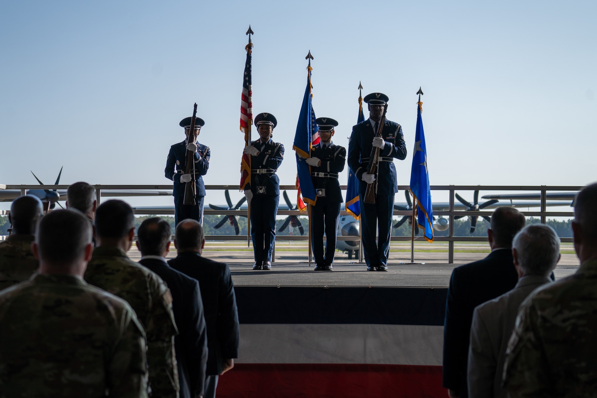 Airmen present the colors in front of a watching crowd