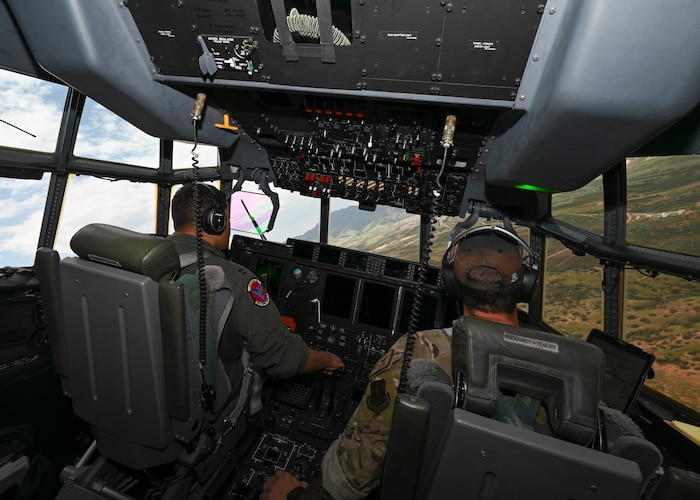 Men in military unforms fly a plane