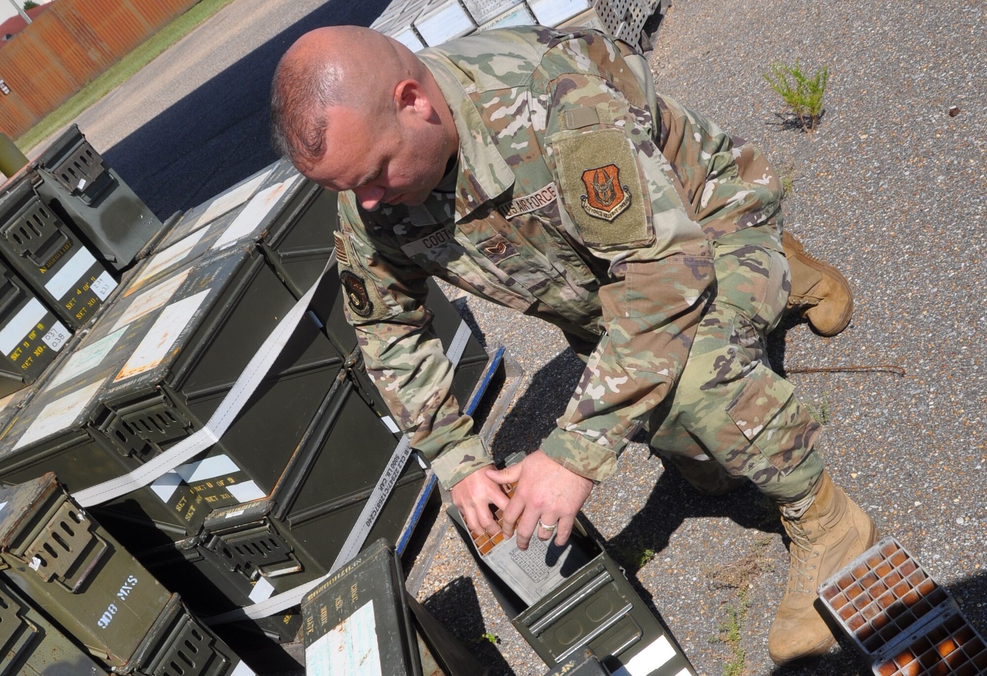 a man works on ammo cans