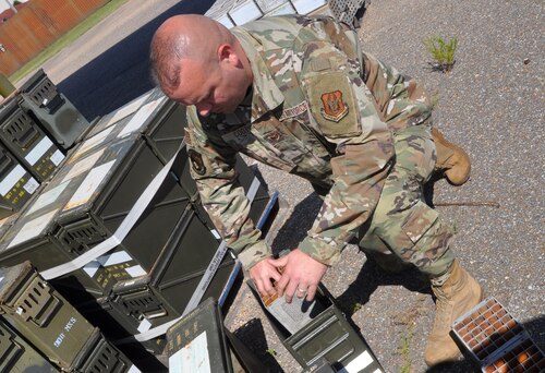 a man works on ammo cans
