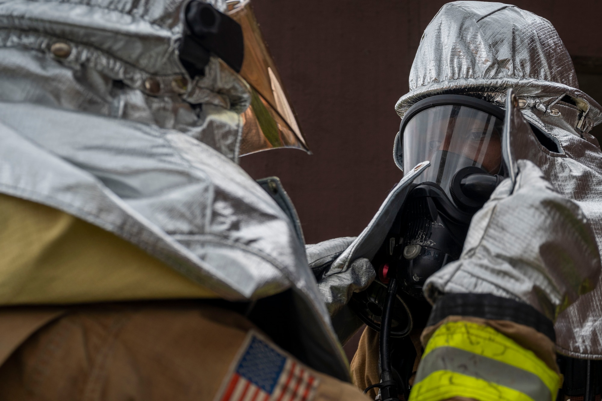 A U.S. Air Force Airman assigned to the 51st Civil Engineer Squadron performs a buddy check on protective equipment before addressing a simulated fire during Ulchi Freedom Shield 24 at Osan Air Base, Republic of Korea, Aug. 22, 2024. The fire emergency services flight is charged with protecting life and property within the boundaries of the installation 24/7. UFS24 is an annual combined exercise conducted in support of the U.S.-ROK Mutual Defense Treaty that highlights the U.S. commitment to the alliance. (U.S. Air Force photo by Senior Airman Kaitlin Frazier)