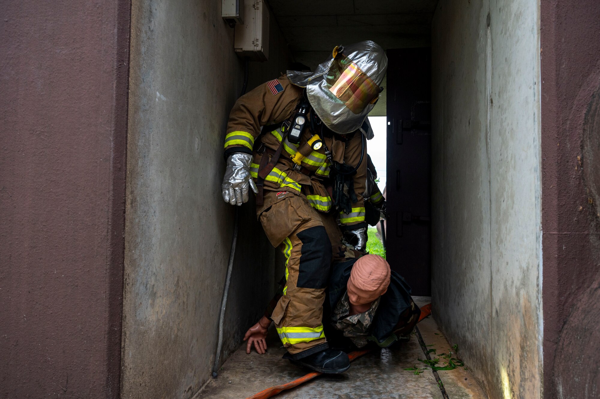 A U.S. Air Force Airman assigned to the 51st Civil Engineer Squadron practices rescue operations in a simulated fire during Ulchi Freedom Shield 24 at Osan Air Base, Republic of Korea, Aug. 22, 2024. After completing the training, the firefighters were briefed on their performance, addressing the importance of remaining vigilant and ensuring the safety of personnel and assets. Training is conducted throughout the year to generate combat airpower at a moment’s notice, affirming the commitment to the ROK remains ironclad and ensures regional stability throughout the U.S. Indo-Pacific Command. UFS24 is an annual combined exercise conducted in support of the U.S.-ROK Mutual Defense Treaty that highlights the U.S. commitment to the alliance. (U.S. Air Force photo by Senior Airman Kaitlin Frazier)