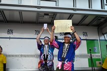 Members of the Misawa City International Association hold up their winning certificates during Misawa City Festival at Misawa City.