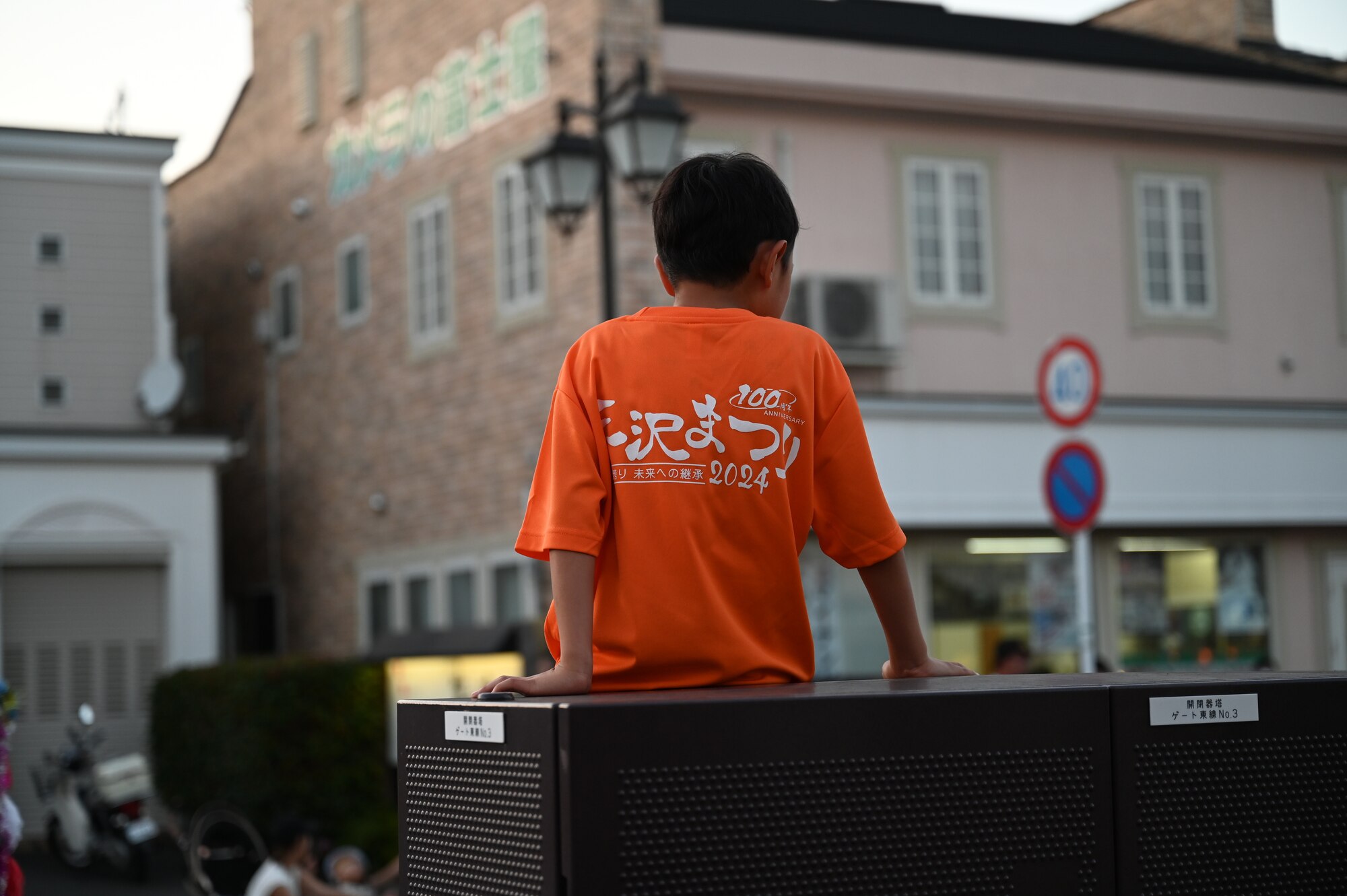 A boy wears a Misawa City Festival 100th anniversary T-shirt at Misawa City