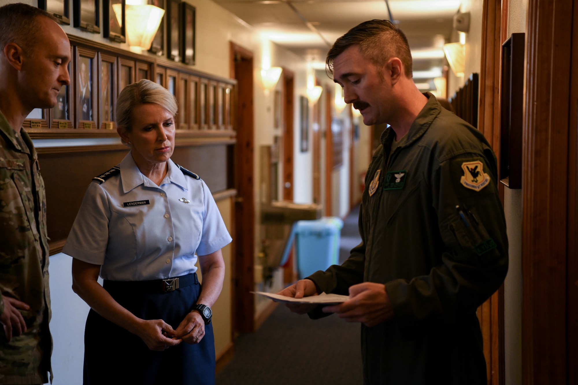 military members talk in a hallway