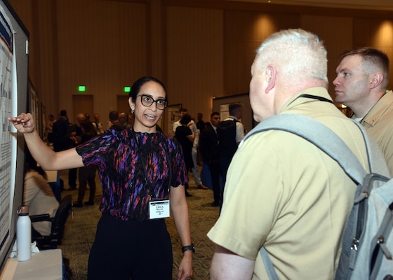 KISSIMMEE, Fla. – (Aug. 27, 2024) – Dr. Erica Molina, of San Antonio, a research scientist assigned to the Combat Casualty Care and Operational Medicine Directorate, Naval Medical Research Unit (NAMRU) San Antonio, briefs research on Pooled Human Freeze Dried Plasmas are Functionally Compatibility during a Post Session One held on day two of the 2024 Military Health System Research Symposium (MHSRS) held at the Gaylord Palms Resort and Convention Center. The MHSRS brings together military, government, academia, and industry experts for four days of critical conversations and intensive idea sharing. Presenters will share their latest research findings and challenges on topics including combat casualty care, military operational medicine, clinical and rehabilitative medicine, medical simulation and information sciences, military infectious diseases, and the radiation health effects. NAMRU San Antonio is one of the leading research and development laboratories for the U.S. Navy under the Department of Defense (DoD) and is one of eight subordinate research commands in the global network of laboratories operating under the Naval Medical Research Command in Silver Spring, Md.  Its mission is to conduct gap driven combat casualty care, craniofacial, and directed energy research to improve survival, operational readiness, and safety of DoD personnel engaged in routine and expeditionary operations. (U.S. Navy photo by Burrell Parmer, NAMRU San Antonio Public Affairs/Released)