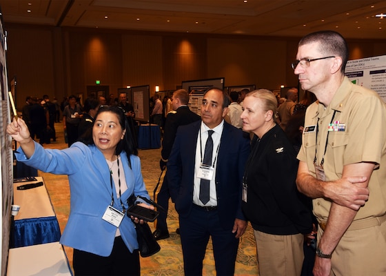 KISSIMMEE, Fla. – (Aug. 27, 2024) – Dr. Heuy-Ching Hetty Wang, of San Antonio, director of Combat Casualty Care and Operational Medicine, Naval Medical Research Unit (NAMRU) San Antonio presented research titled “Pirfenidone Modulates the Secretion of Soluble Factors by Induced Pluripotent Stem Cell-Derived Retinal Pigment Epithelium in an In Vitro Model of Proliferative Vitreoretinopathy” to NAMRU San Antonio leadership during Poster Session One on day two of the 2024 Military Health System Research Symposium (MHSRS) held at the Gaylord Palms Resort and Convention Center. The MHSRS brings together military, government, academia, and industry experts for four days of critical conversations and intensive idea sharing. Presenters will share their latest research findings and challenges on topics including combat casualty care, military operational medicine, clinical and rehabilitative medicine, medical simulation and information sciences, military infectious diseases, and the radiation health effects. NAMRU San Antonio is one of the leading research and development laboratories for the U.S. Navy under the Department of Defense (DoD) and is one of eight subordinate research commands in the global network of laboratories operating under the Naval Medical Research Command in Silver Spring, Md.  Its mission is to conduct gap driven combat casualty care, craniofacial, and directed energy research to improve survival, operational readiness, and safety of DoD personnel engaged in routine and expeditionary operations. (U.S. Navy photo by Burrell Parmer, NAMRU San Antonio Public Affairs/Released)