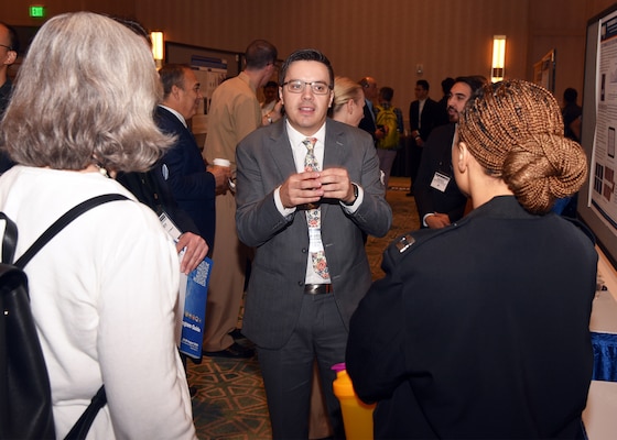 KISSIMMEE, Fla. – (Aug. 27, 2024) – Dr. Daniel Thompson, of Sandy, Utah, a research scientist, assigned to the Craniofacial Health and Restorative Medicine Directorate, Naval Medical Research Unit (NAMRU) San Antonio, presented research titled “Biocompatibility and Antimicrobial Properties of Endodontic Bioceramic Sealers In Vitro” during Poster Session One on day two of the 2024 Military Health System Research Symposium (MHSRS) held at the Gaylord Palms Resort and Convention Center. The MHSRS brings together military, government, academia, and industry experts for four days of critical conversations and intensive idea sharing. Presenters will share their latest research findings and challenges on topics including combat casualty care, military operational medicine, clinical and rehabilitative medicine, medical simulation and information sciences, military infectious diseases, and the radiation health effects. NAMRU San Antonio is one of the leading research and development laboratories for the U.S. Navy under the Department of Defense (DoD) and is one of eight subordinate research commands in the global network of laboratories operating under the Naval Medical Research Command in Silver Spring, Md.  Its mission is to conduct gap driven combat casualty care, craniofacial, and directed energy research to improve survival, operational readiness, and safety of DoD personnel engaged in routine and expeditionary operations. (U.S. Navy photo by Burrell Parmer, NAMRU San Antonio Public Affairs/Released)