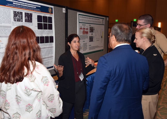 KISSIMMEE, Fla. – (Aug. 27, 2024) – Dr. Jessica Saul-McBeth, a research scientist, assigned to the Craniofacial Health and Restorative Medicine Directorate, Naval Medical Research Unit (NAMRU) San Antonio, presented research titled “Engineering Neutrophil-Membrane Coated Nanoparticles as an Effective Drug Delivery System During Ischemia Reperfusion Injury on the Battlefield” during Poster Session One on day two of the 2024 Military Health System Research Symposium (MHSRS) held at the Gaylord Palms Resort and Convention Center. The MHSRS brings together military, government, academia, and industry experts for four days of critical conversations and intensive idea sharing. Presenters will share their latest research findings and challenges on topics including combat casualty care, military operational medicine, clinical and rehabilitative medicine, medical simulation and information sciences, military infectious diseases, and the radiation health effects. NAMRU San Antonio is one of the leading research and development laboratories for the U.S. Navy under the Department of Defense (DoD) and is one of eight subordinate research commands in the global network of laboratories operating under the Naval Medical Research Command in Silver Spring, Md.  Its mission is to conduct gap driven combat casualty care, craniofacial, and directed energy research to improve survival, operational readiness, and safety of DoD personnel engaged in routine and expeditionary operations. (U.S. Navy photo by Burrell Parmer, NAMRU San Antonio Public Affairs/Released)