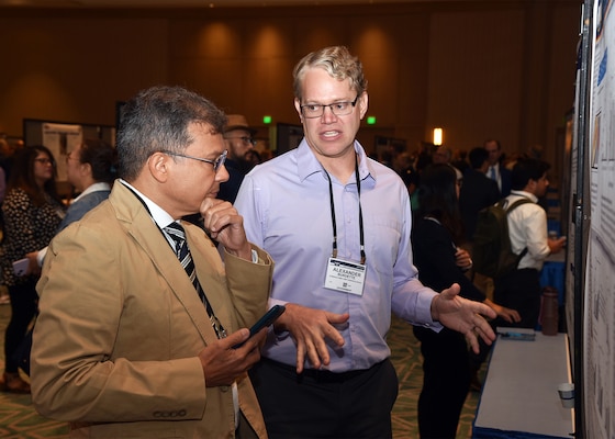 KISSIMMEE, Fla. – (Aug. 27, 2024) – Alexander Burdette, a research scientist, assigned to the Combat Casualty Care and Operational Medicine Directorate, Naval Medical Research Unit (NAMRU) San Antonio, presented research on A Novel Shape Memory Polymer Scaffold in Combination with Delayed Bone Marrow-Derived Mesenchymal Stem Cells during Poster Session One on day two of the 2024 Military Health System Research Symposium (MHSRS) held at the Gaylord Palms Resort and Convention Center. The MHSRS brings together military, government, academia, and industry experts for four days of critical conversations and intensive idea sharing. Presenters will share their latest research findings and challenges on topics including combat casualty care, military operational medicine, clinical and rehabilitative medicine, medical simulation and information sciences, military infectious diseases, and the radiation health effects. NAMRU San Antonio is one of the leading research and development laboratories for the U.S. Navy under the Department of Defense (DoD) and is one of eight subordinate research commands in the global network of laboratories operating under the Naval Medical Research Command in Silver Spring, Md.  Its mission is to conduct gap driven combat casualty care, craniofacial, and directed energy research to improve survival, operational readiness, and safety of DoD personnel engaged in routine and expeditionary operations. (U.S. Navy photo by Burrell Parmer, NAMRU San Antonio Public Affairs/Released)