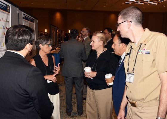 KISSIMMEE, Fla. – (Aug. 27, 2024) – Research scientists Tarea Burton and Andres Martinez Murillo, assigned to Craniofacial Health and Restorative Medicine Directorate, Naval Medical Research Unit (NAMRU) San Antonio, presented research titled, “Testing and Evaluation of a Portable Ozone Sterilizer: Bacterial Reduction Efficacy” to NAMRU San Antonio leadership during Poster Session One on day two of the 2024 Military Health System Research Symposium (MHSRS) held at the Gaylord Palms Resort and Convention Center. The MHSRS brings together military, government, academia, and industry experts for four days of critical conversations and intensive idea sharing. Presenters will share their latest research findings and challenges on topics including combat casualty care, military operational medicine, clinical and rehabilitative medicine, medical simulation and information sciences, military infectious diseases, and the radiation health effects. NAMRU San Antonio is one of the leading research and development laboratories for the U.S. Navy under the Department of Defense (DoD) and is one of eight subordinate research commands in the global network of laboratories operating under the Naval Medical Research Command in Silver Spring, Md.  Its mission is to conduct gap driven combat casualty care, craniofacial, and directed energy research to improve survival, operational readiness, and safety of DoD personnel engaged in routine and expeditionary operations. (U.S. Navy photo by Burrell Parmer, NAMRU San Antonio Public Affairs/Released)