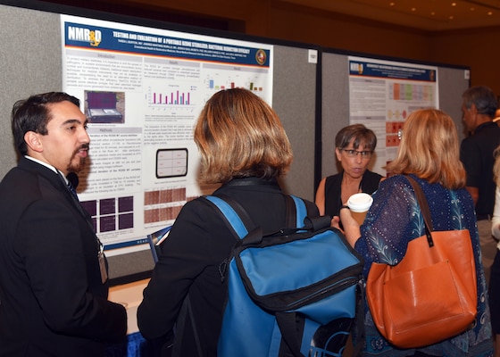 KISSIMMEE, Fla. – (Aug. 27, 2024) – Research scientists Andres Martinez Murillo and Tarea Burton, assigned to Craniofacial Health and Restorative Medicine Directorate, Naval Medical Research Unit (NAMRU) San Antonio, presented research titled, “Testing and Evaluation of a Portable Ozone Sterilizer: Bacterial Reduction Efficacy” during Poster Session One on day two of the 2024 Military Health System Research Symposium (MHSRS) held at the Gaylord Palms Resort and Convention Center. The MHSRS brings together military, government, academia, and industry experts for four days of critical conversations and intensive idea sharing. Presenters will share their latest research findings and challenges on topics including combat casualty care, military operational medicine, clinical and rehabilitative medicine, medical simulation and information sciences, military infectious diseases, and the radiation health effects. NAMRU San Antonio is one of the leading research and development laboratories for the U.S. Navy under the Department of Defense (DoD) and is one of eight subordinate research commands in the global network of laboratories operating under the Naval Medical Research Command in Silver Spring, Md.  Its mission is to conduct gap driven combat casualty care, craniofacial, and directed energy research to improve survival, operational readiness, and safety of DoD personnel engaged in routine and expeditionary operations. (U.S. Navy photo by Burrell Parmer, NAMRU San Antonio Public Affairs/Released)