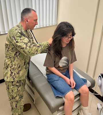 U.S. Naval Hospital Okinawa's Executive Officer Capt. James Demitrack helps out during a Sports Physical Rodeo on a Saturday morning to help free up routine pediatric appointments during PSC season.